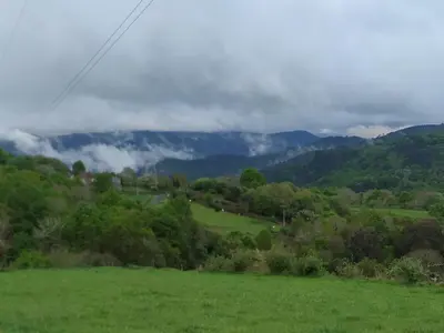 a green field with mountains in the background at TOURON Nº1 in Carballedo