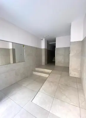 a room with a hallway with white walls and tile floors at Lemos Sol in Monforte de Lemos