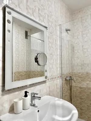 a bathroom with a sink and a mirror and a shower at Lemos Sol in Monforte de Lemos