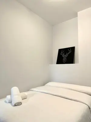 a white room with two beds and a picture on the wall at Lemos Sol in Monforte de Lemos