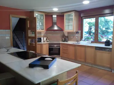 a kitchen with a large island with a scale on it at CASA DE CIMADEVILA in Santiso