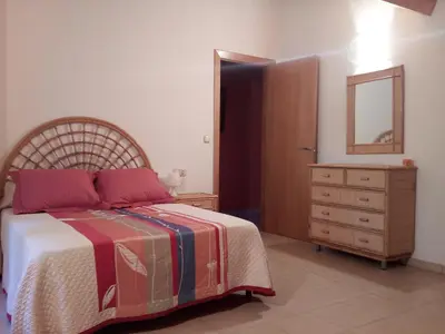 a bedroom with a bed and a dresser and a mirror at CASA DE CIMADEVILA in Santiso