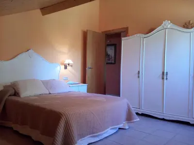 a bedroom with a bed and a large white cabinet at CASA DE CIMADEVILA in Santiso