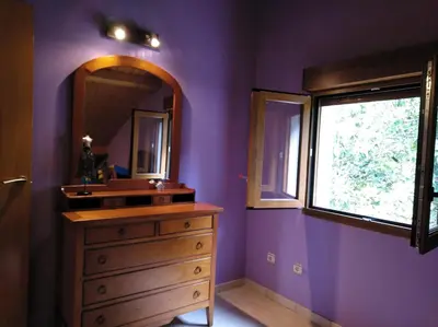 a bathroom with a wooden dresser and a mirror at CASA DE CIMADEVILA in Santiso