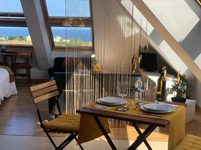 a dining table and chairs in a living room at El Rinconcito de Foz in Foz
