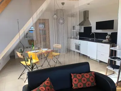 a living room with a couch and a table and a kitchen at El Rinconcito de Foz in Foz