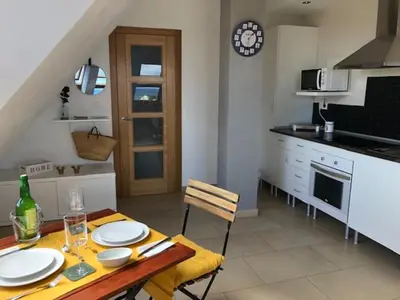 a kitchen with a table with plates on it at El Rinconcito de Foz in Foz