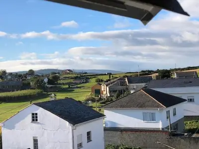 a view of a town with houses and a field at El Rinconcito de Foz in Foz