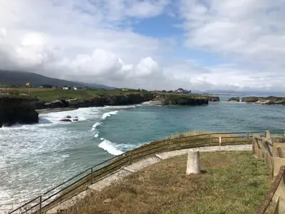 a view of a body of water with a fence at El Rinconcito de Foz in Foz