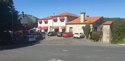 a street with cars parked in front of a building at Hotel A Forxa Cafetería Restaurante in Carballeira