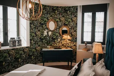 a bedroom with a desk and a mirror at 1930 Boutique Hotel in Arzúa