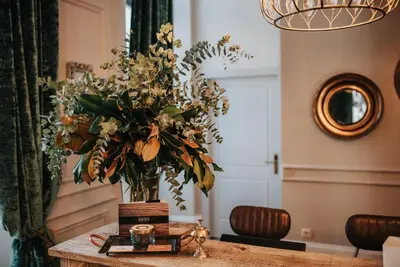 a vase of flowers sitting on a table at 1930 Boutique Hotel in Arzúa