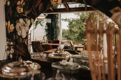 a dining room with tables and chairs and a mirror at 1930 Boutique Hotel in Arzúa