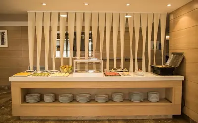 a buffet line with plates of food on display at Hotel Gelmírez in Santiago de Compostela
