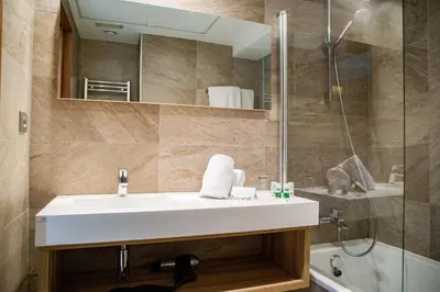 a bathroom with a sink and a shower at Hotel Gelmírez in Santiago de Compostela