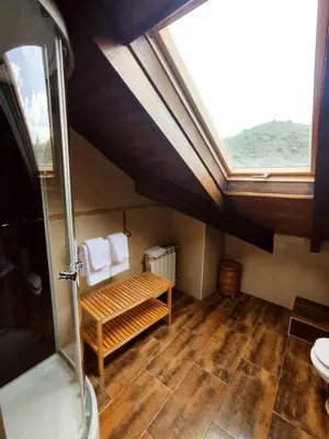 a bathroom with a sink and a skylight at Hotel Rural Pajarapinta in Molinaseca