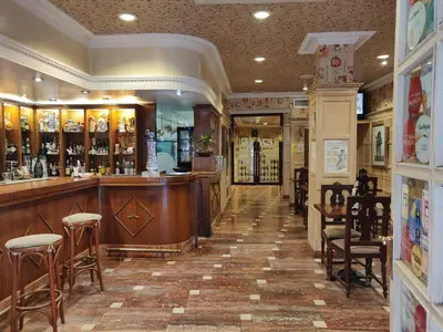a bar in a restaurant with chairs and tables at Hotel Chef Rivera in Padrón