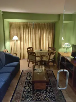 a living room with a blue couch and a table at Hotel Chef Rivera in Padrón
