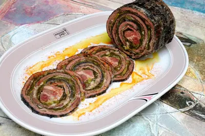 a plate of food with a roll of meat at Hotel Chef Rivera in Padrón