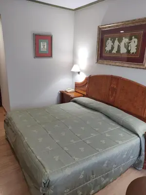 a bedroom with a bed and a table and a picture at Hotel Chef Rivera in Padrón