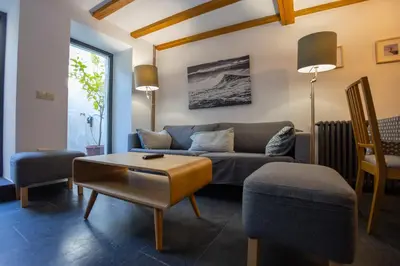 a living room with a couch and a table at Casa Jovellanos de Casas Das Figueiras en Ría Eo-Ribadeo in Castropol