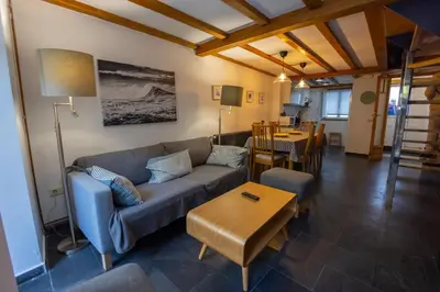 a living room with a couch and a table at Casa Jovellanos de Casas Das Figueiras en Ría Eo-Ribadeo in Castropol