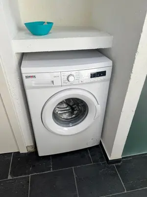 a washer and dryer in a corner of a room at Casa Jovellanos de Casas Das Figueiras en Ría Eo-Ribadeo in Castropol