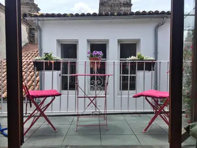 a patio with two chairs and a table on a balcony at Albergue Azabache in Santiago de Compostela