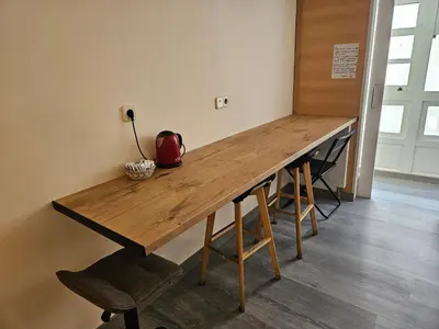 a room with a colorful table in front of a window at Albergue Azabache in Santiago de Compostela