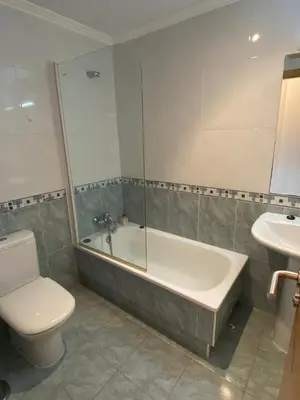 a bathroom with a tub and a toilet and a sink at Carmen in Caldas de Reis