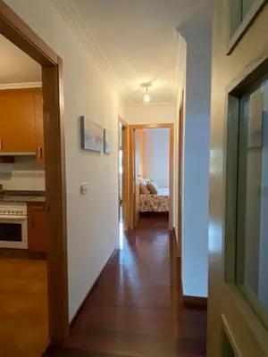 a hallway leading to a kitchen and a bedroom at Carmen in Caldas de Reis