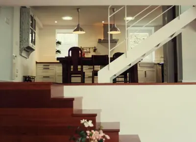 a kitchen and dining room with a staircase in a house at La Postoca in Viavélez