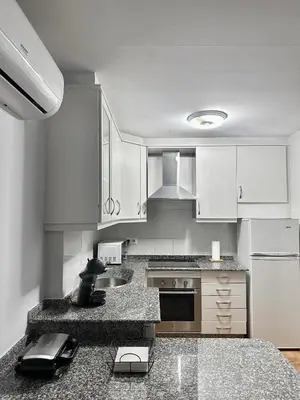 a kitchen with white cabinets and a counter top at Lemos Luna in Monforte de Lemos