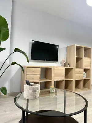 a living room with a tv and a glass table at Lemos Luna in Monforte de Lemos