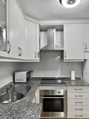 a kitchen with a sink and a stove top oven at Lemos Luna in Monforte de Lemos