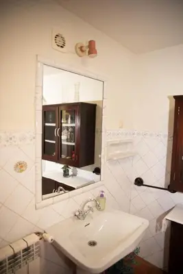 a bathroom with a cabinet with dishes in it at Casa de Piñeiro y SPA Opcional con coste extra in Santiago de Compostela