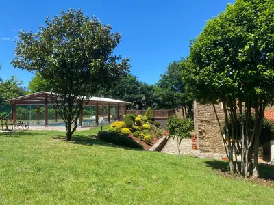 a park with trees and a pavilion in the background at Casa Compostela in Bama