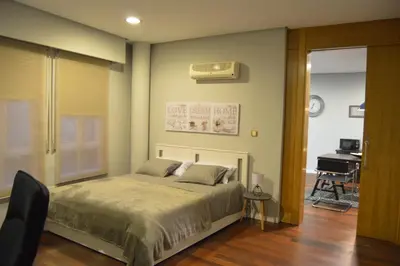 a bedroom with a bed with a air conditioner on the wall at ÁGORA LUX in Ourense