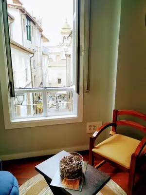 a table with a bowl of food on it next to a window at ÁGORA LUX in Ourense