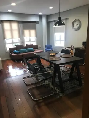 a living room with a table and chairs and a couch at ÁGORA LUX in Ourense