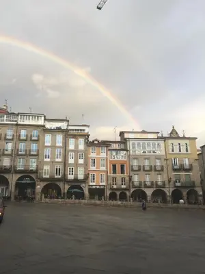 a rainbow in front of a group of buildings at ÁGORA LUX in Ourense