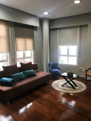 a living room with a couch and a table at ÁGORA LUX in Ourense