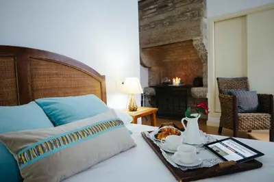 a bedroom with a bed with a tray with a trayasteryasteryasteryasteryastery at Hotel Arco de Mazarelos in Santiago de Compostela