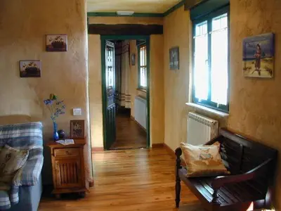 a living room with a couch and a hallway at Hostería Casa Flor in Murias de Rechivaldo