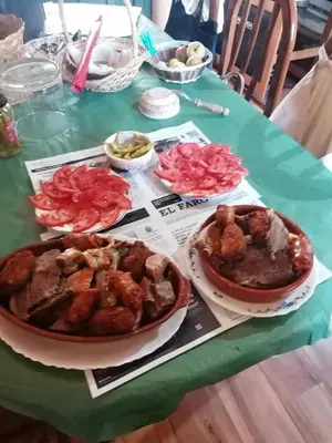 a table topped with plates of food on a table at Hostería Casa Flor in Murias de Rechivaldo