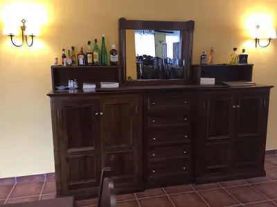 a wooden dresser with a mirror on top of it at Hotel Rural Nova Ruta in Trabadelo