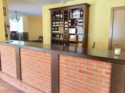a bar in a restaurant with a brick wall at Hotel Rural Nova Ruta in Trabadelo