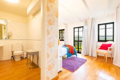 a bedroom with a bed and a bathroom at Eira Grande Galicia Villas in Pedre