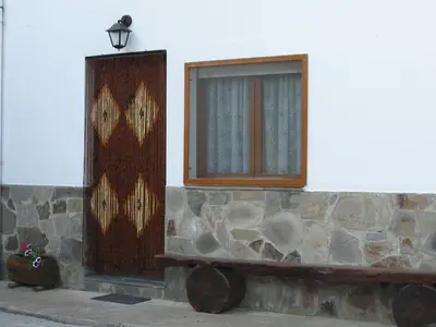 a window on the side of a building with a bench at Apartamentos Rurales Casa El Caminero in Merás