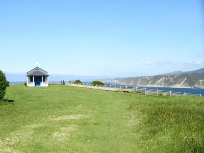 a building on a hill next to the water at Apartamentos Rurales Casa El Caminero in Merás